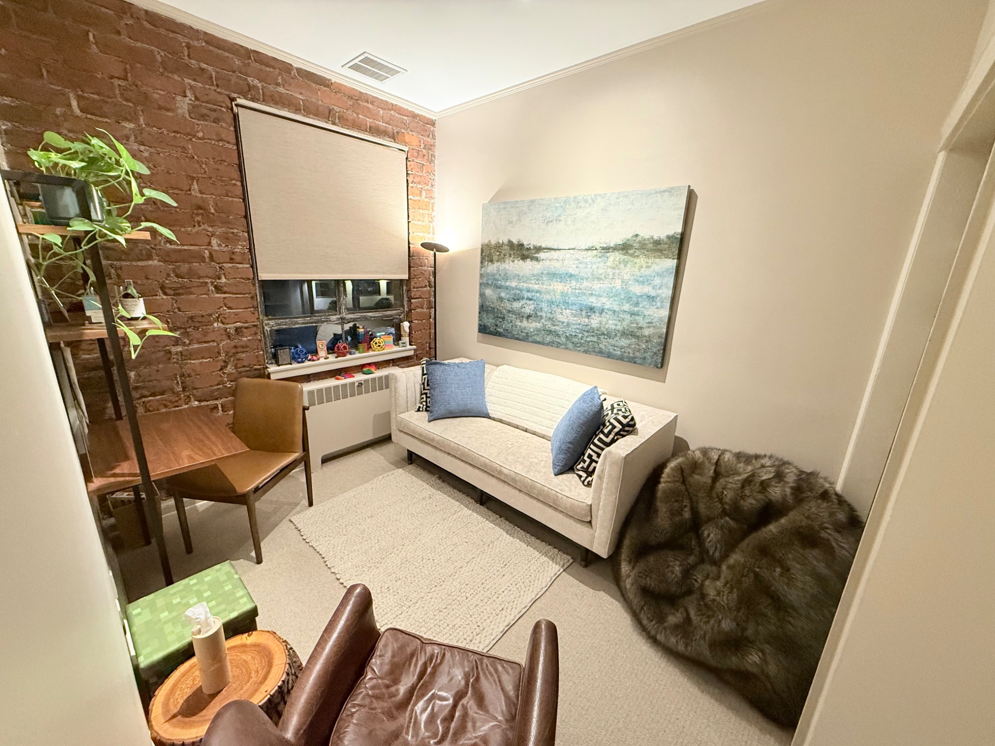 Therapy room with ocean painting and couch
