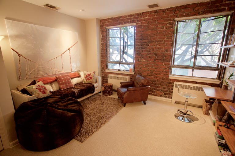 Therapy room with brick wall and cozy seating