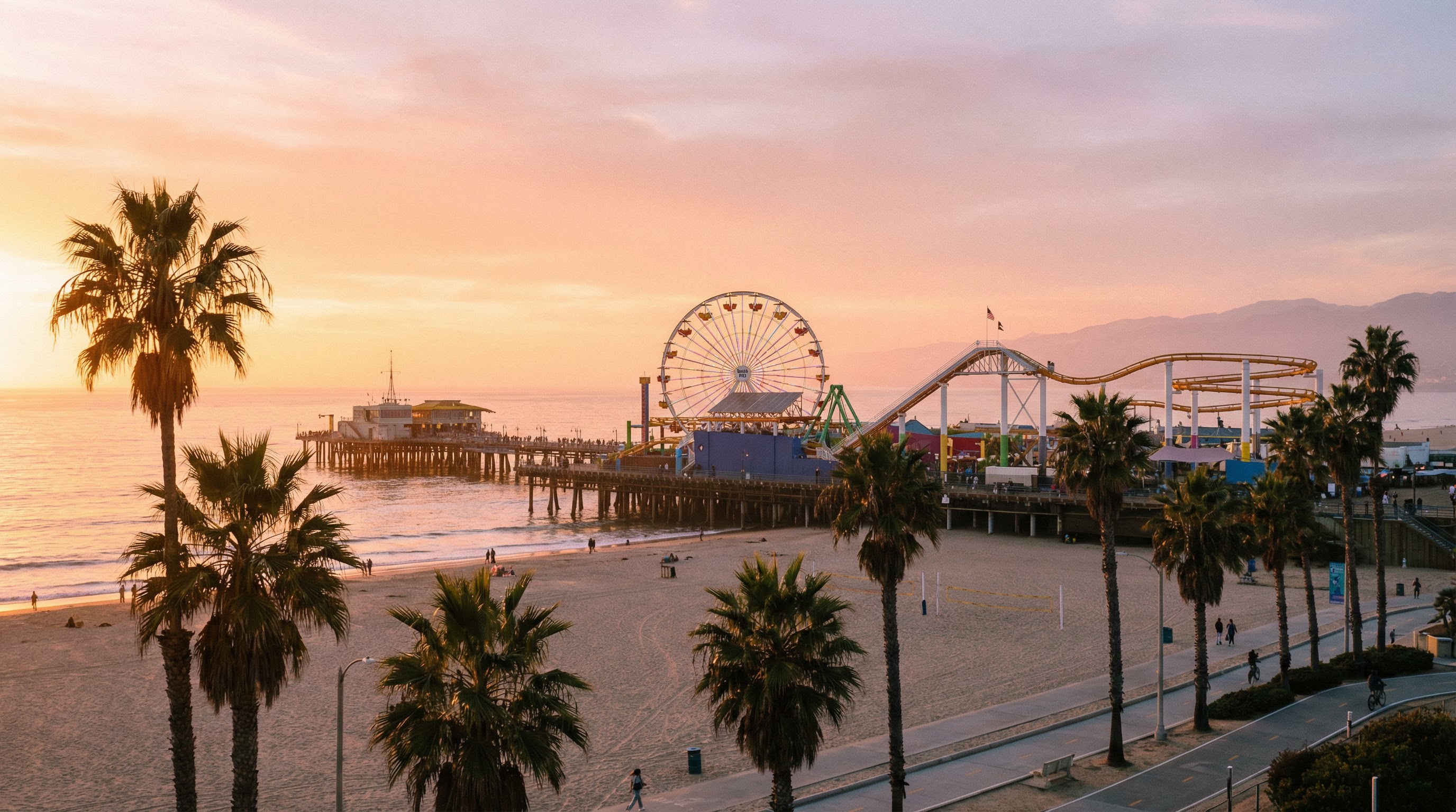 Santa Monica Pier at sunset with palm trees and Ferris wheel